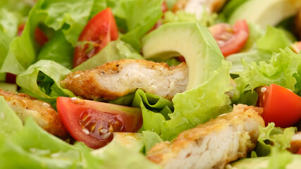 chicken salad with avocado, tomatoes, lettuce, sesame seeds. Healthy salad with chicken