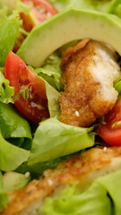 chicken salad with avocado, tomatoes, lettuce, sesame seeds. Healthy salad with chicken