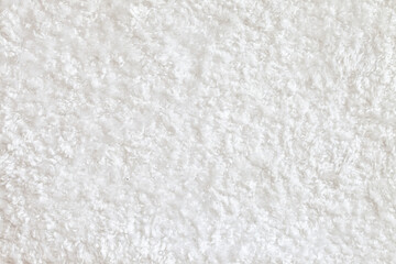 Fototapeta na wymiar White fluffy carpet texture. Soft luxury Shag Rug. Short shag carpet surface. Domextic high-density white rug.