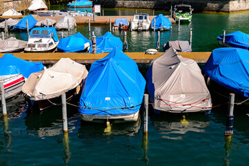 Fototapeta na wymiar Boats on the river Limmat in Zurich, the largest city in Switzerland