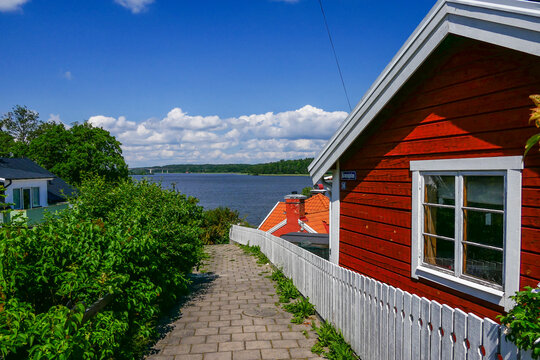 Strangnas, Sweden A Small Red House On A Path Overlooking Lake Malaren.