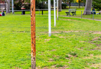 Four Australian football goal posts, one that is very rusted, at a suburban football oval in Brunswick East ,Melbourne, Australia