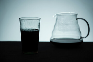 Silhouette Image of Coffee. a Glass with Black Coffee and a Server on Table
