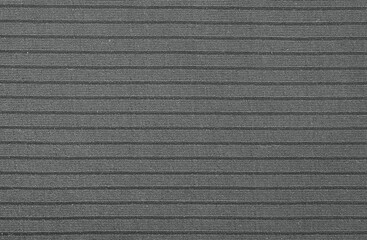 Texture of black plastic striped relief fabric. Overhead shot. Closeup shot. Macro photography....