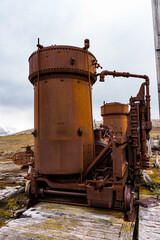 Fototapeta na wymiar Broken Mining equipment in the New London settlement, Svalbard archipelago