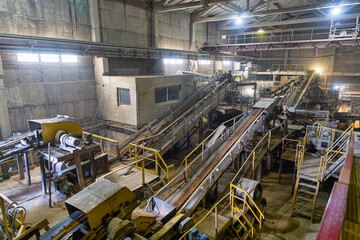Transportation and sorting of clay on conveyor. Brickworks. Production workshop inside. Manufacturing facility