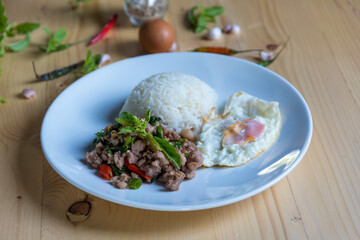 Rice topped of Food Rice topped with stir-fried pork and basil on wood background.  Thai  street food in Thailand. traditional food style,  street food in Thailand.