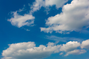 Gray and white clouds on blue sky background.