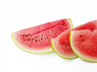Bright juicy red watermelon cut into slices on a white background. Space for text.