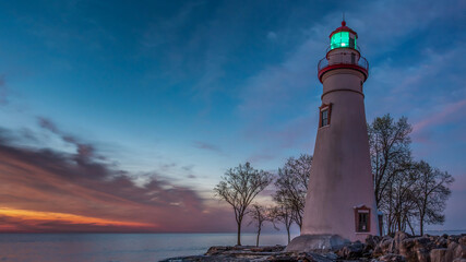 Marblehead Lighthouse at sunrise with beacon shining
