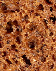 Black rye bread as an abstract background