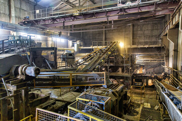 Transportation and sorting of clay on conveyor. Brickworks. Production workshop inside....