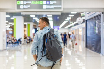 Young man with backpack in airport in terminal