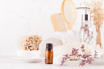 Fresh clean white cosmetic product and natural beauty accessories for skin cleansing, body care with violet dry flowers on white wood table, closeup.