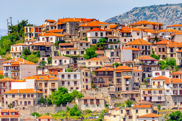 Fototapeta na wymiar It's Houses of Arachova, Greece. A village on the green slopes of Parnassus Mountains, Greece