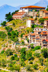 Fototapeta na wymiar It's Houses of Arachova, Greece. A village on the green slopes of Parnassus Mountains, Greece