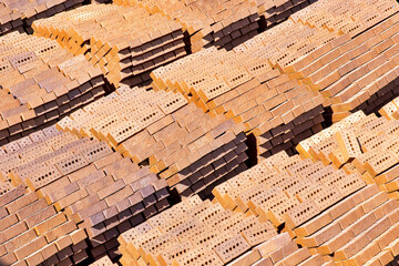 Pallets with bricks in a warehouse of a brick factory.