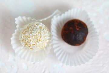 Candies covered by shredded coconut. coconut balls with coconut flakes. top view