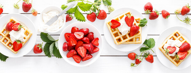 Traditional belgian waffles with cream cheese and fresh strawberry on white background, banner