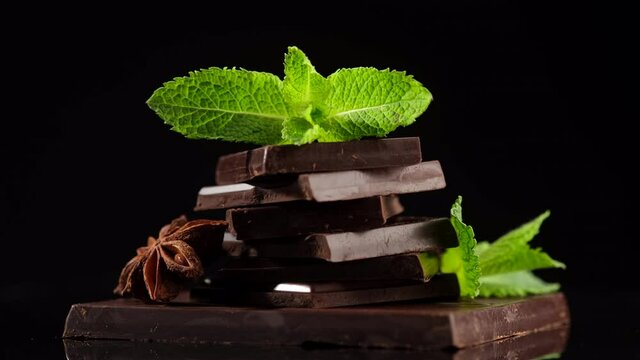 chocolate. dark chocolate bar stack with mint leaf rotating. Confectionery, confection concept.