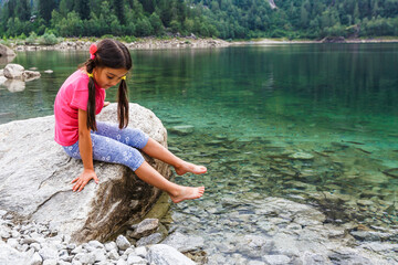 little girl looking to italy mountains