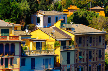 Fototapeta na wymiar It's Close view of the colorful houses in Portofino, an Italian fishing village, Genoa province, Italy. A vacation resort with a picturesque harbour and with celebrity and artistic visitors.