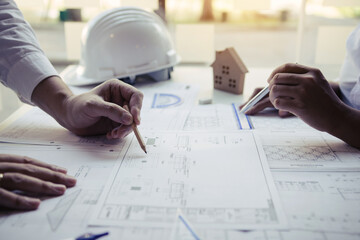 Engineers are helping to design work on blueprints and collaborate on structural analyzing of...