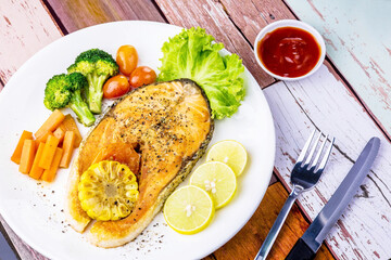 Salmon steak on wooden plate