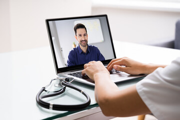 Doctor Talking To Male Patient Through Video Chat
