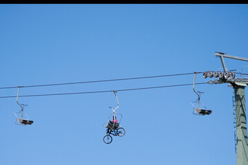 cable car of blue sky and a mountain biker 