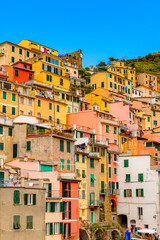 Fototapeta na wymiar It's Beautiful view of Riomaggiore (Rimazuu), a village in province of La Spezia, Liguria, Italy. It's one of the lands of Cinque Terre, UNESCO World Heritage Site