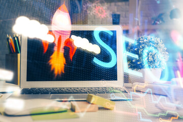 Double exposure of table with computer and seo drawing hologram. Search optimization concept.