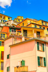 Fototapeta na wymiar It's Houses of Riomaggiore (Rimazuu), a village in province of La Spezia, Liguria, Italy. It's one of the lands of Cinque Terre, UNESCO World Heritage Site