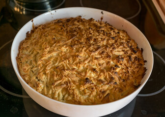 a white baking bowl and a ready cake in it