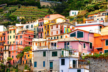 Fototapeta na wymiar It's Houses on the mountains of Manarola (Manaea), a small town in province of La Spezia, Liguria, Italy. It's one of the lands of Cinque Terre, UNESCO World Heritage Site