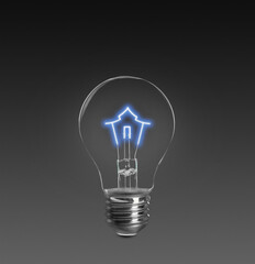 Light bulb with tungsten filament in shape on house on dark background. Energy efficiency, loan, property or business idea concepts