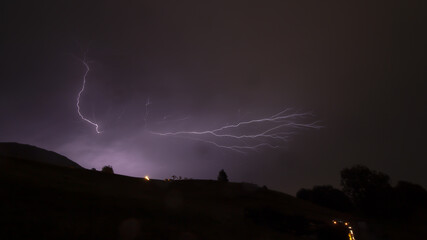 Naklejka na ściany i meble lightning strikes during a thunderstorm over the Swiss countryside