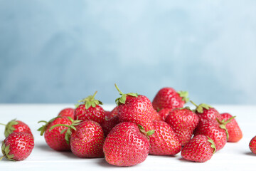 Delicious ripe strawberries on white table, closeup