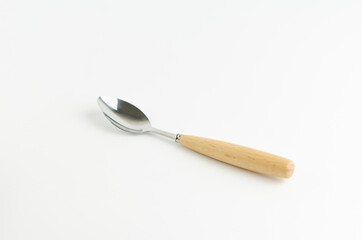 Tea spoon with a wooden handle on white background