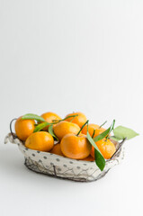 Fresh mandarin oranges fruit or tangerines with leaves on white background