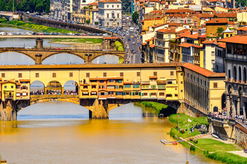 It's Ponte Vecchio (Old Bridge), a Medieval stone closed-spandrel segmental arch bridge over the Arno River, in Florence, Italy. View from the Michelangelo Square