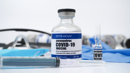 Covid-19 Corona Virus 2019-ncov Vaccine vials medicine drug ampoule bottle syringe injection medical nitrile gloves mask glasses. Vaccination, treatment to cure Covid 19 Corona Virus infection.