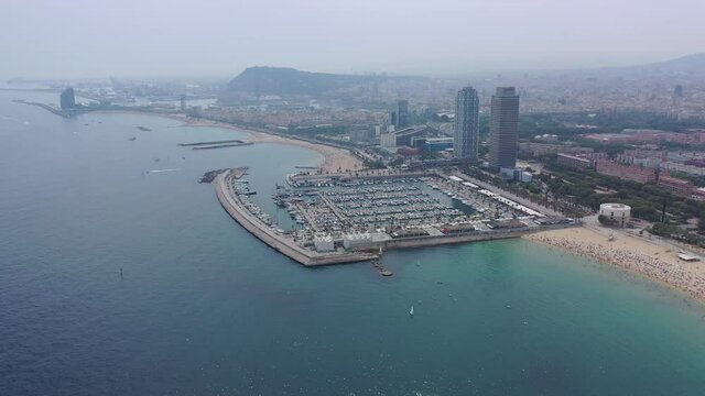 BARCELONA, SPAIN - JULY 07, 2019: Aerial panoramic view of modern Barcelona cityscape on Mediterranean coast 