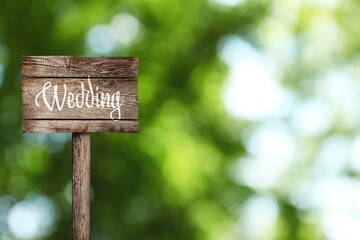 Wooden plaque with inscription Wedding outdoors, space for text