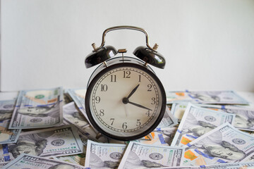 Alarm clock on money banknotes Dollars, concept of business planning and finance. Usurer, credit concept. Time for quick money.Time management, business investment, planning