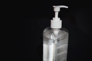 Fototapeta na wymiar Hand sanitizer bottle with black background.