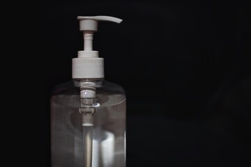 Fototapeta na wymiar Hand sanitizer bottle with black background.