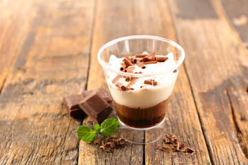 chocolate mousse and cream on wood background
