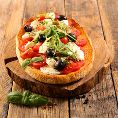 bruschetta with tomato, basil, mozzarella and olive