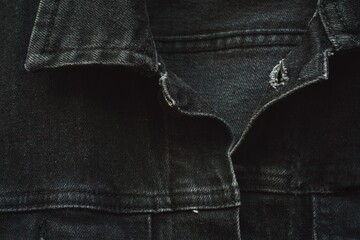 Close up of black jeans jacket fabric.